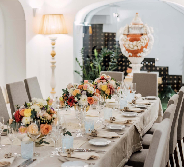 Elegant indoor dining room set for private celebrations with refined table setting at Palazzo Pascal