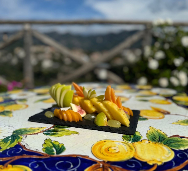 Fresh fruit served on a ceramic table during an outdoor breakfast experience on the Amalfi Coast