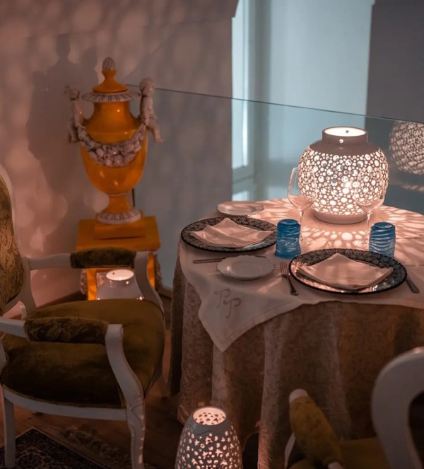 Elegant romantic dinner table setup with candles and refined decorative details