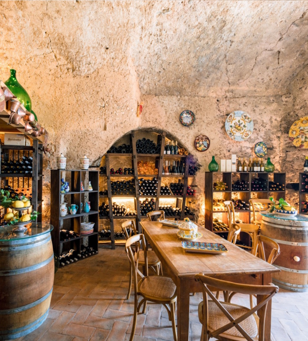 Group wine tasting experience in a traditional Amalfi Coast cellar with communal table and selected Italian wines